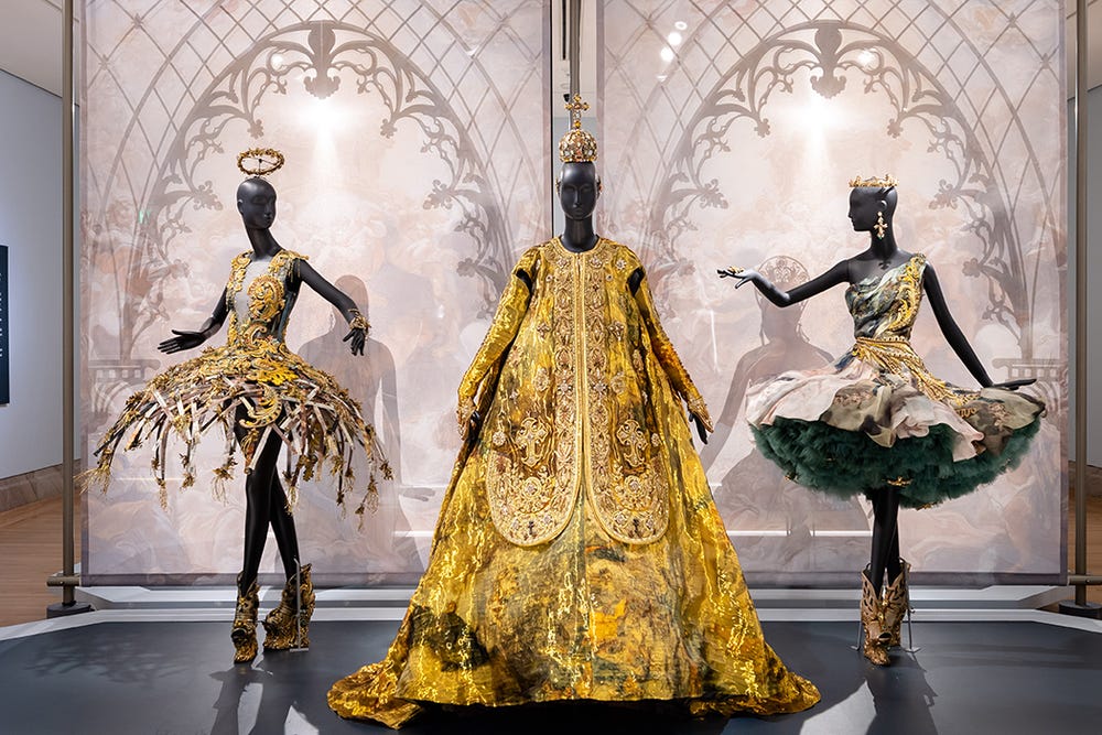 Three gold couture dresses in Guo Pei installation at the Legion of Honor