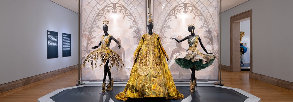 Three gold couture dresses in Guo Pei installation at the Legion of Honor