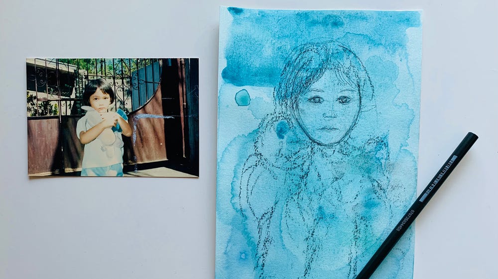 Photograph of young child next to blue painting of photograph
