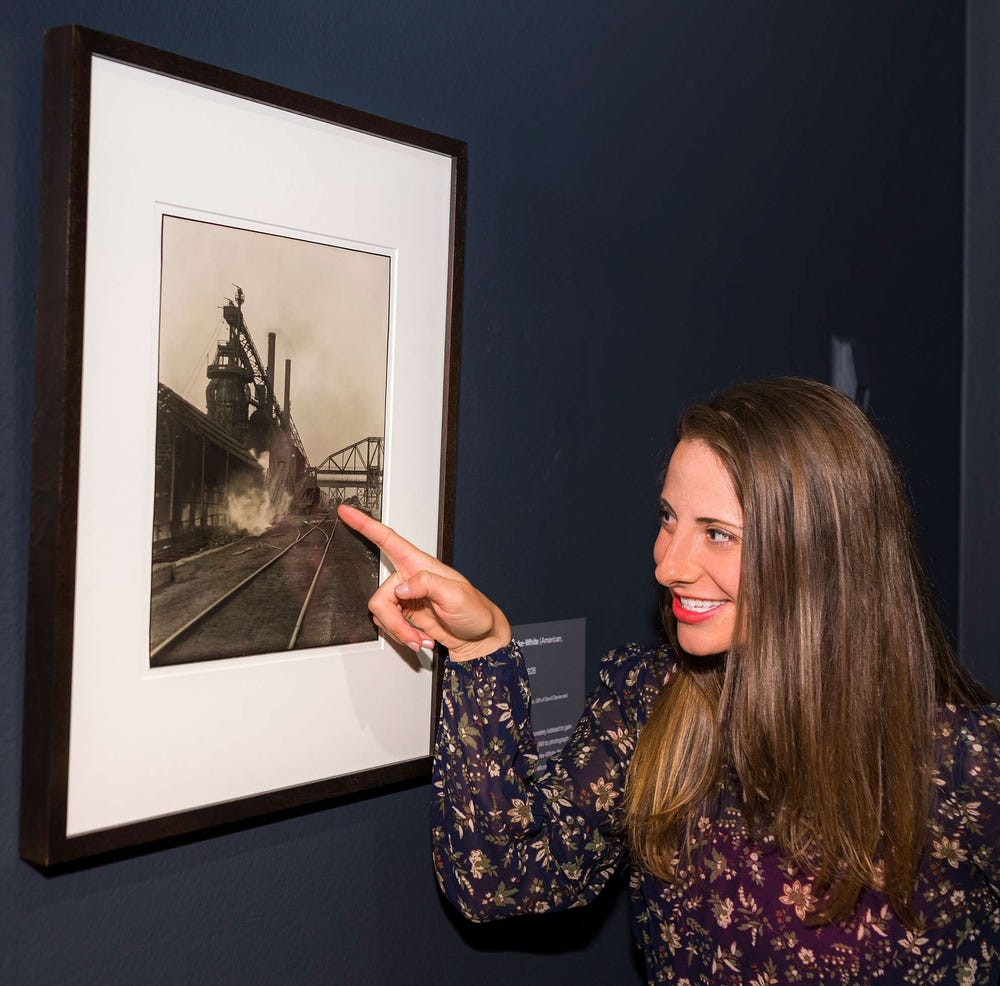 a woman pointing at a photograph