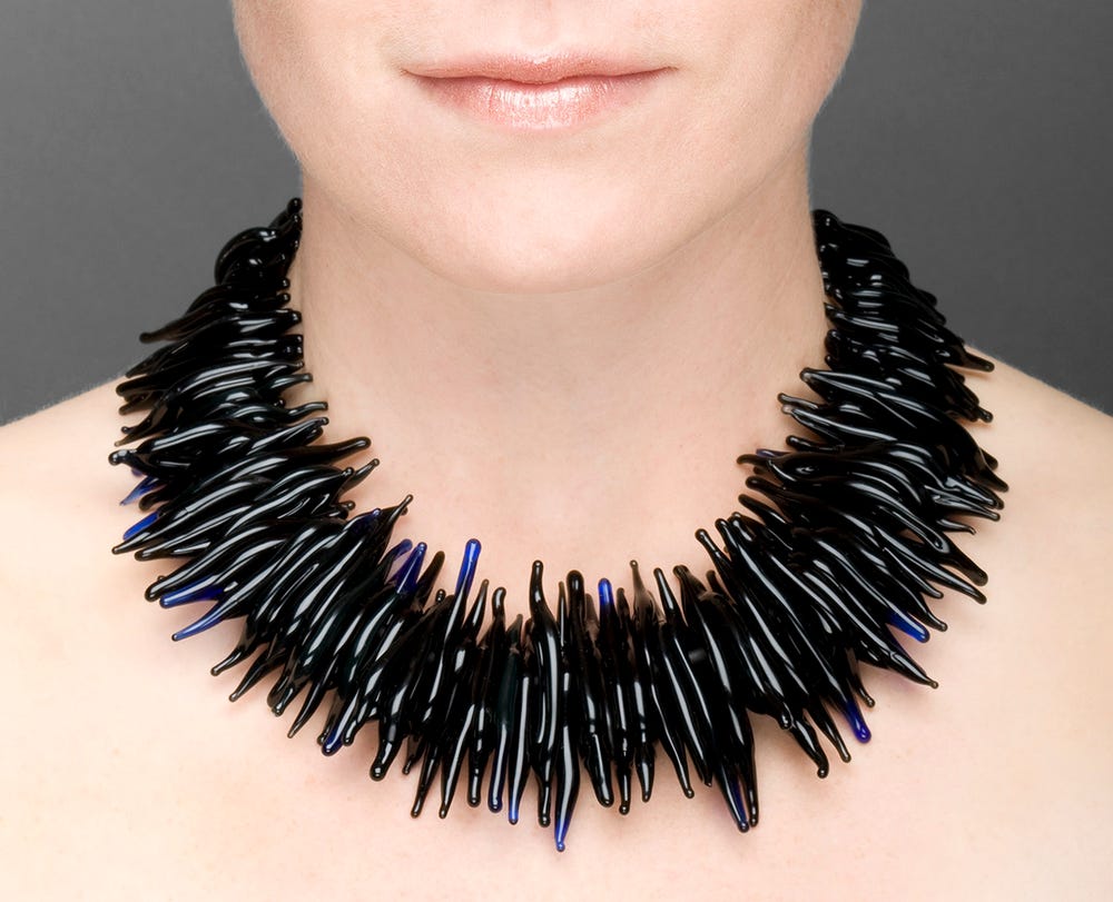 Photograph of black statement necklace on model.