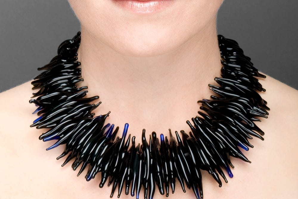 Photograph of black statement necklace on model.