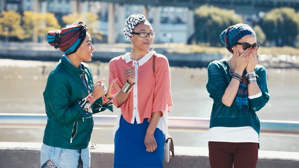video still with three women with head scarves