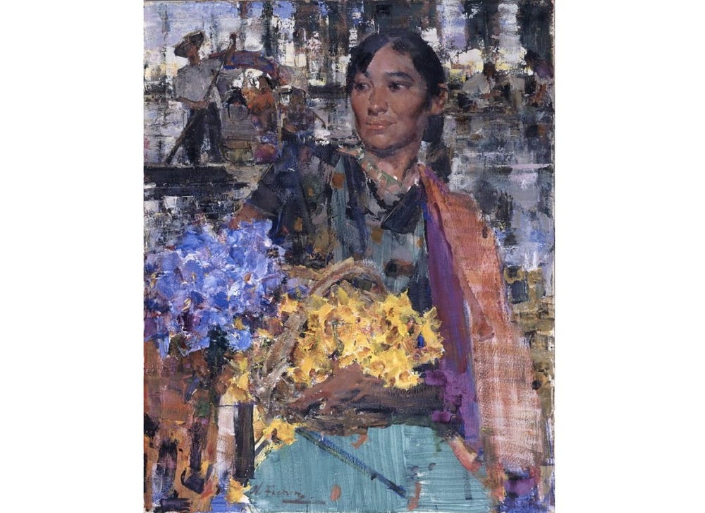 woman with black hair holding basket of blue and yellow flowers