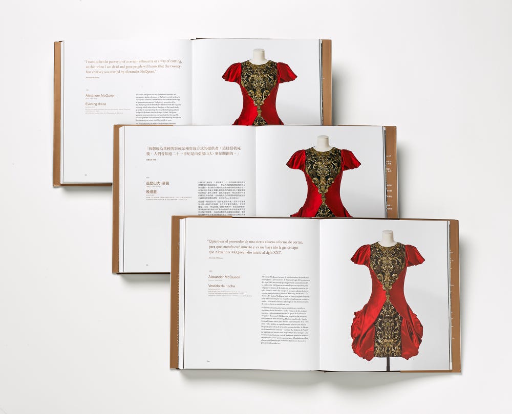 book showing a page with an extravagant red dress