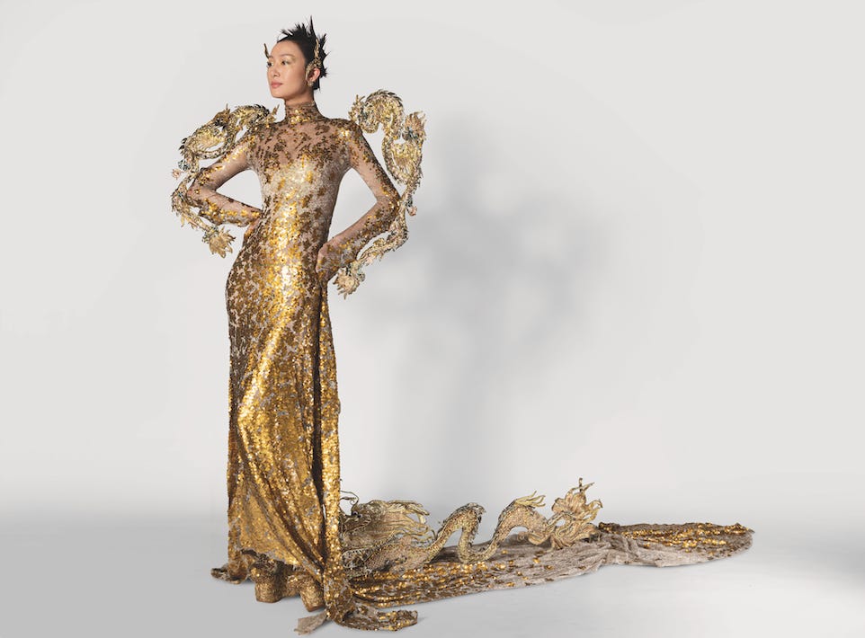 Photograph of model wearing intricate gold dress