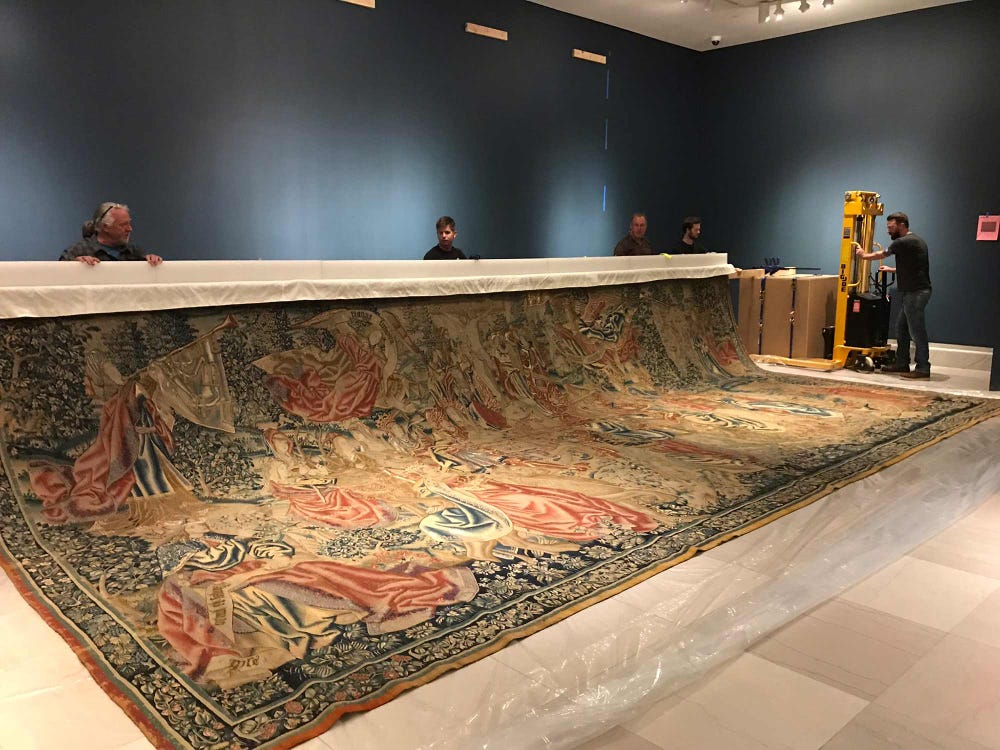 team raising the batten of a tapestry