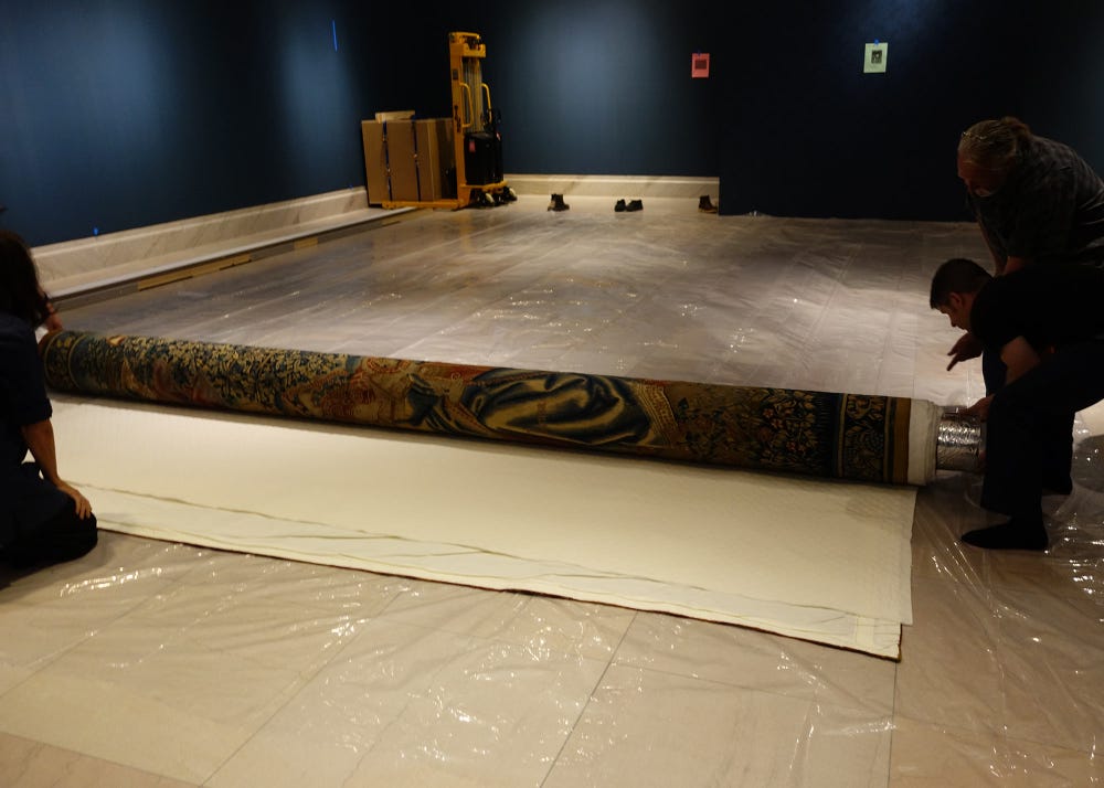 tapestry being unrolled