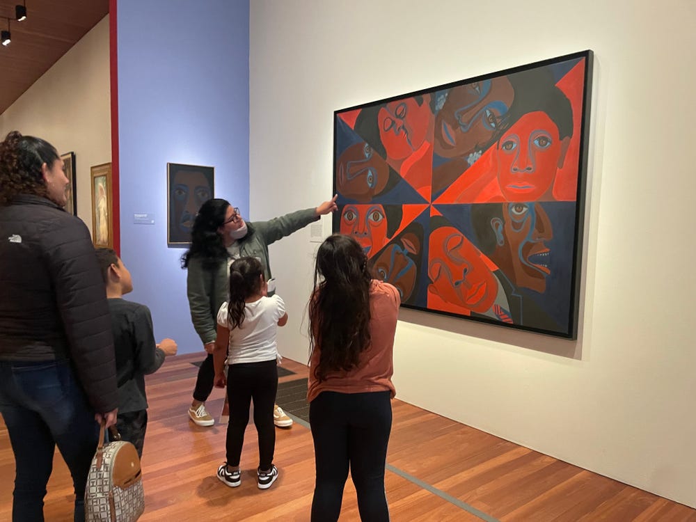 Students on a tour of the Faith Ringgold exhibition at the de Young