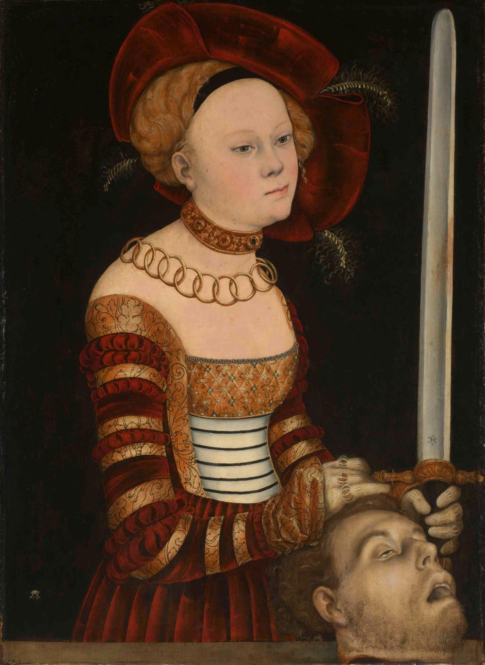Woman holding a sword and the head of a man