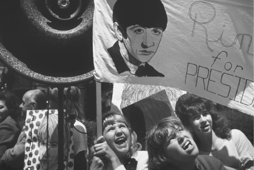 Black and white photo of people holding signs at a rally.