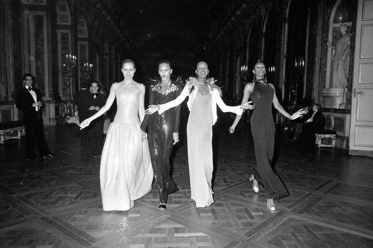 Models walking through the Palace of Versailles
