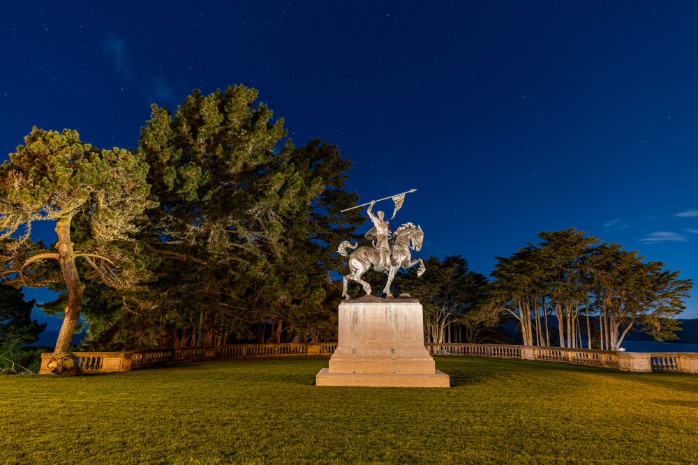 statue of a El Cid Campeador on a horse at night