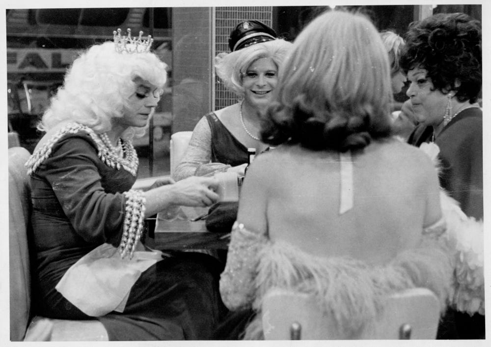 Drag performers sitting at a table