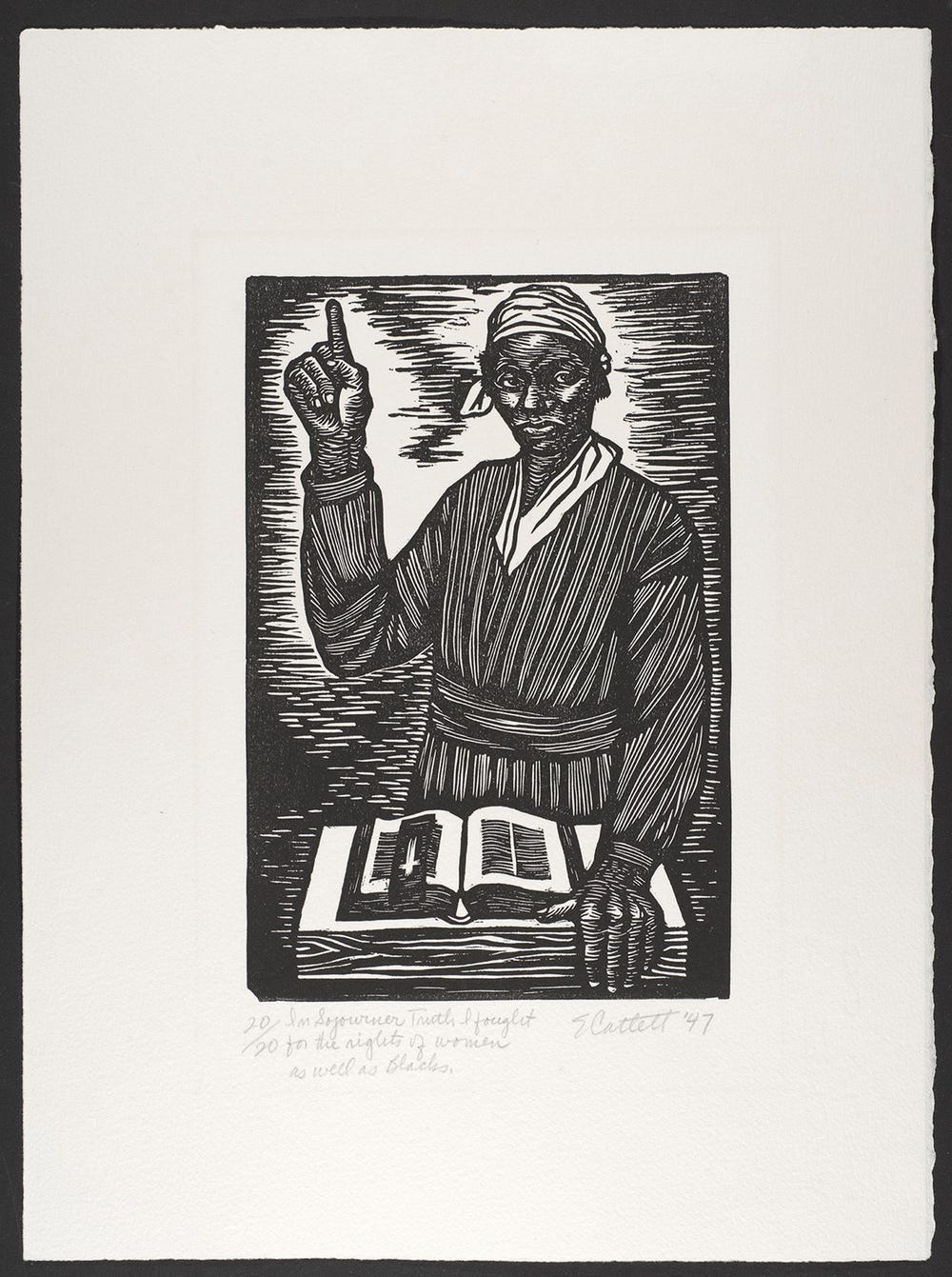 Black woman standing over a book with her finger raised