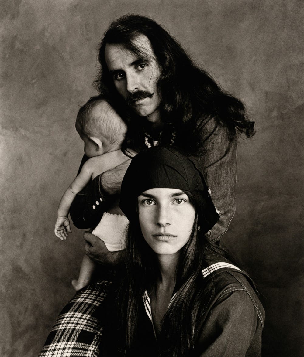 Black and white photograph of two adults and a child by Irving Penn