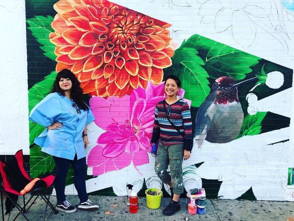 Elaine Chu and Marina Perez-Wong in front of a mural