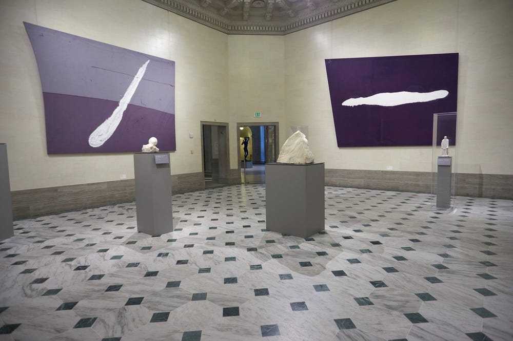 installation view of purple and white paintings