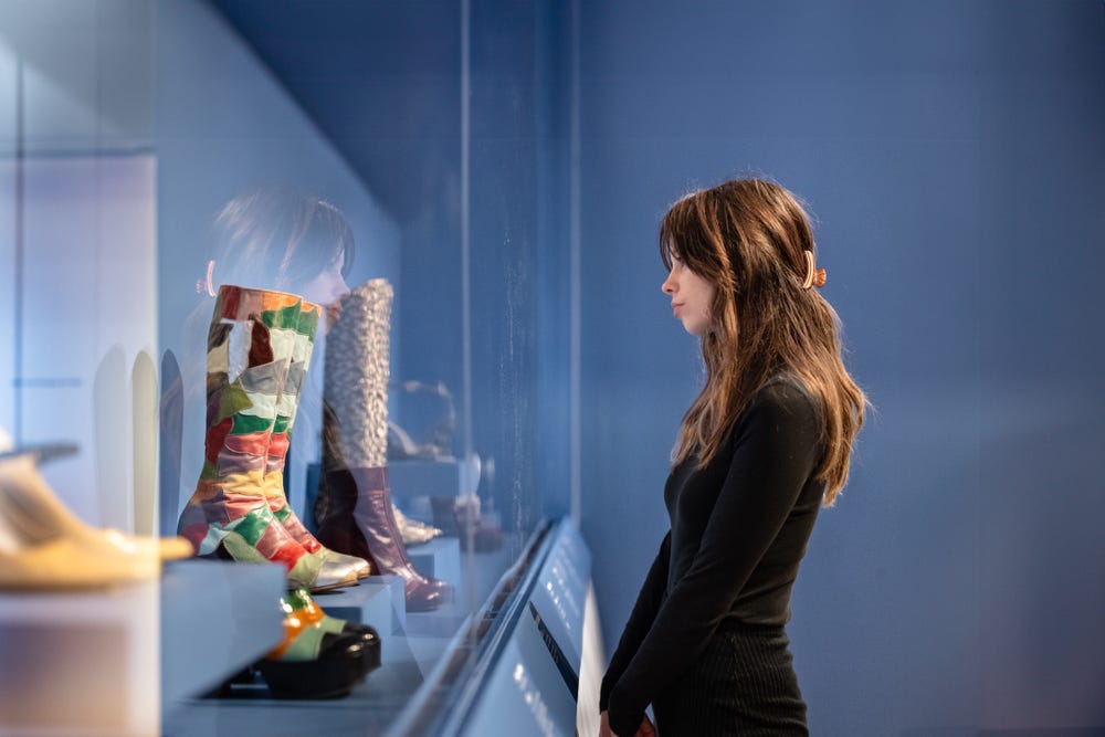 Person looking at shoes in Fashioning San Francisco at the de Young