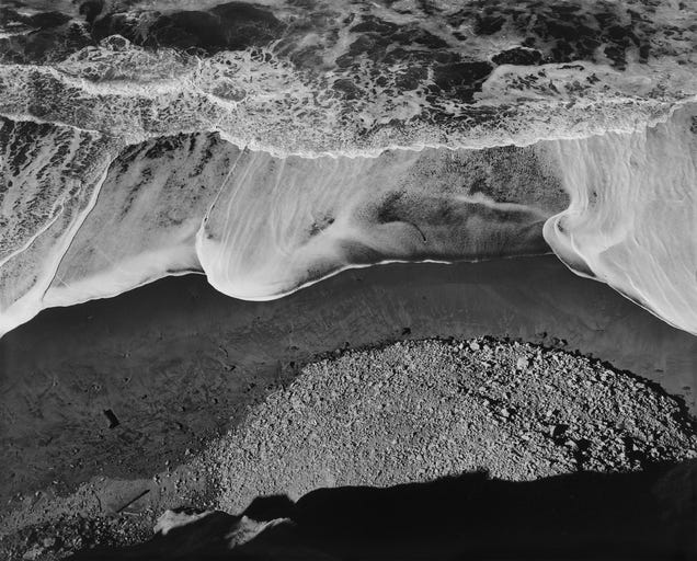 Black and white photograph of ocean surf by Ansel Adams