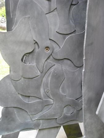 metal sculpture with grayish paint