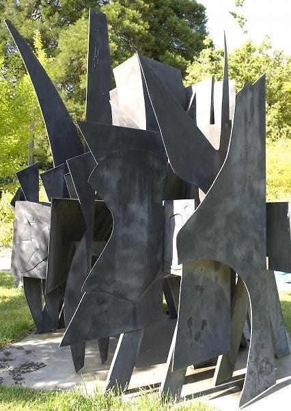 metal sculpture with grayish paint