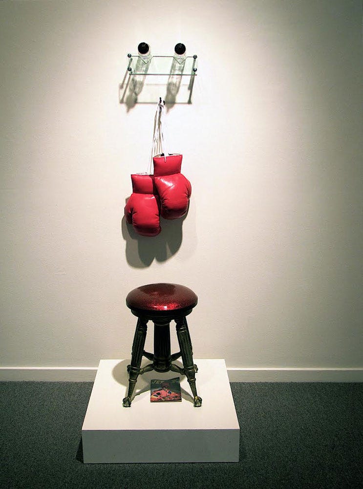 Boxing gloves hanging above a stool