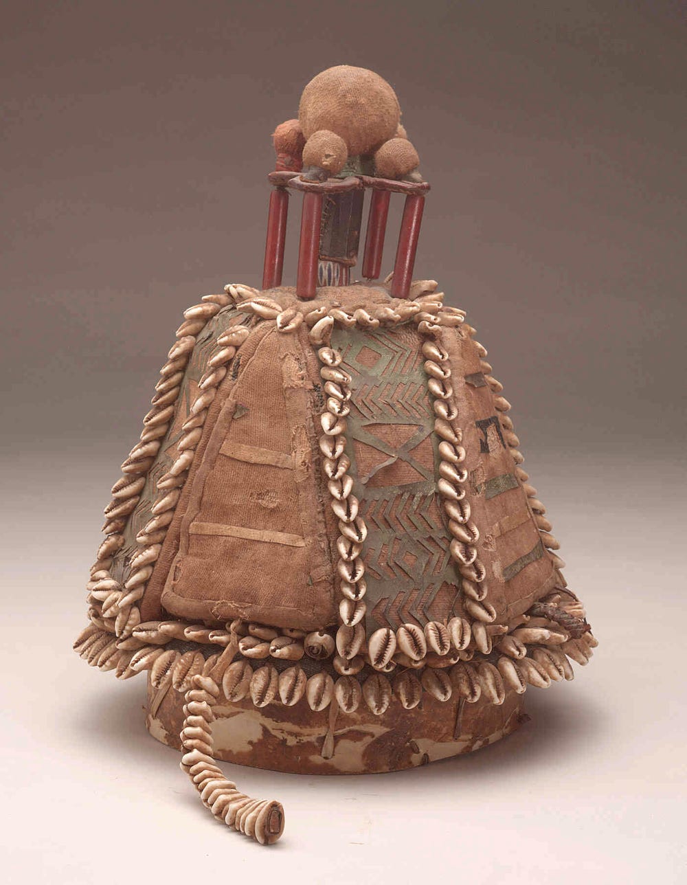 Vessel covered in shells, leather, and beads