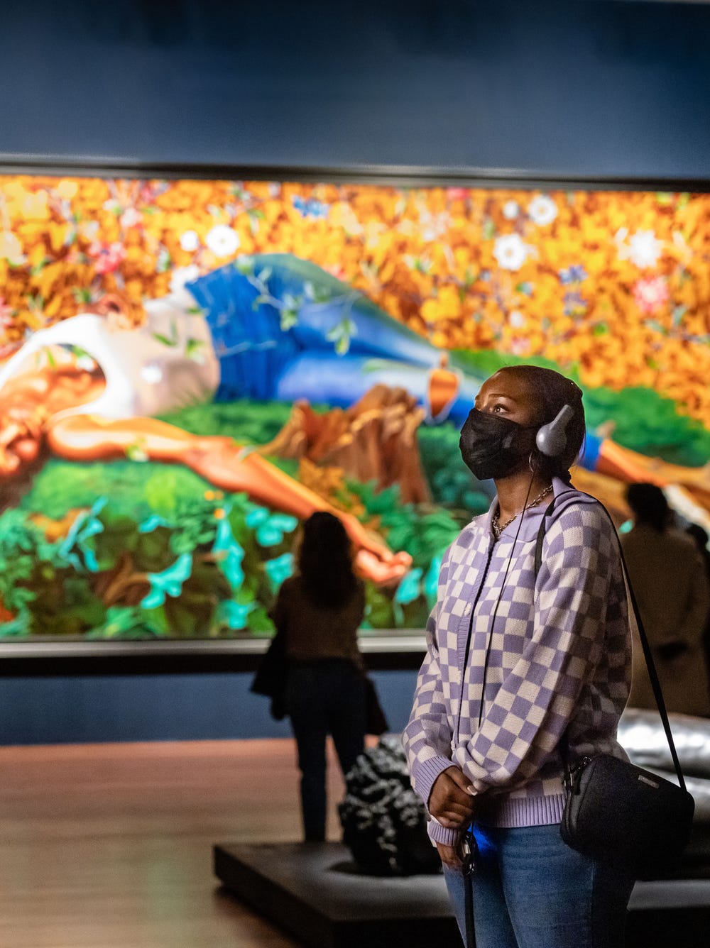 Person looking at Kehinde Wiley artwork at de Young museum