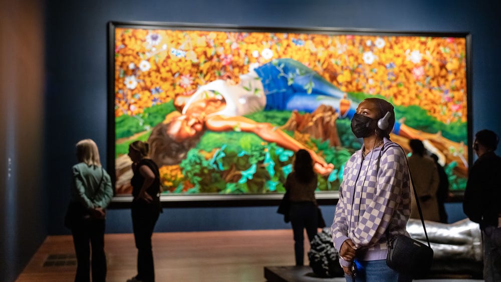 Person looking at Kehinde Wiley artwork at de Young museum