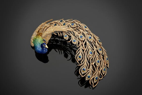 Peacock jewelry in gold, blue, and green.