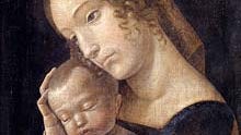 Woman holding a baby against her chest