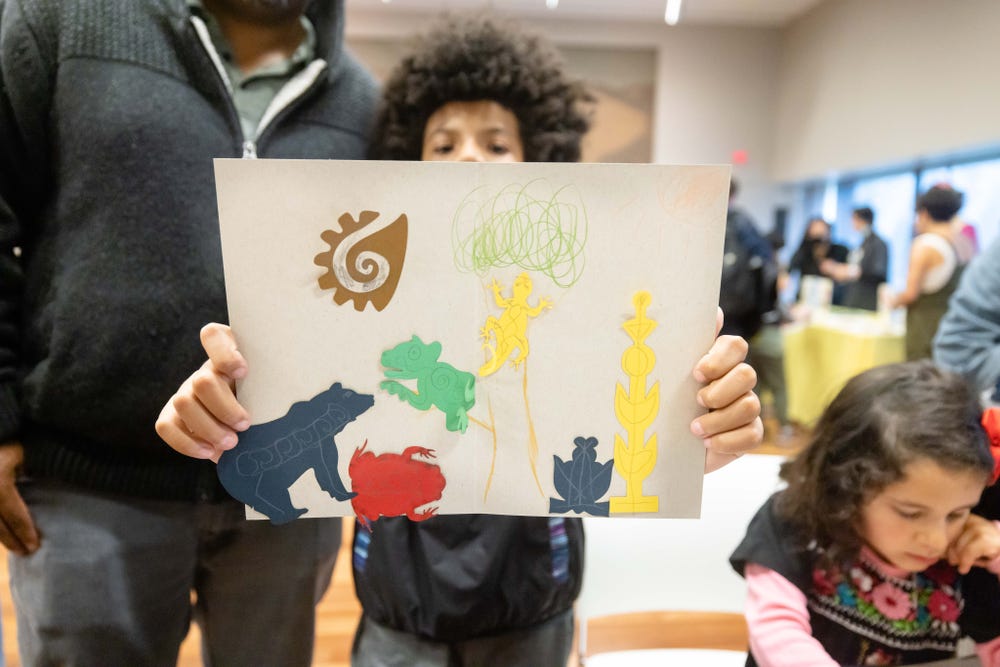 Child holding up artwork