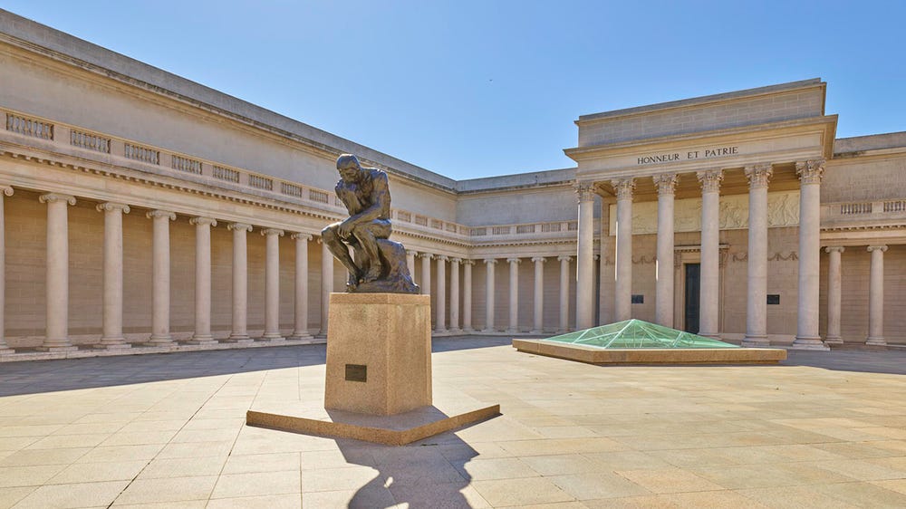 Sculpture of a man with his head resting on his fist in Legion of Honor courtyard