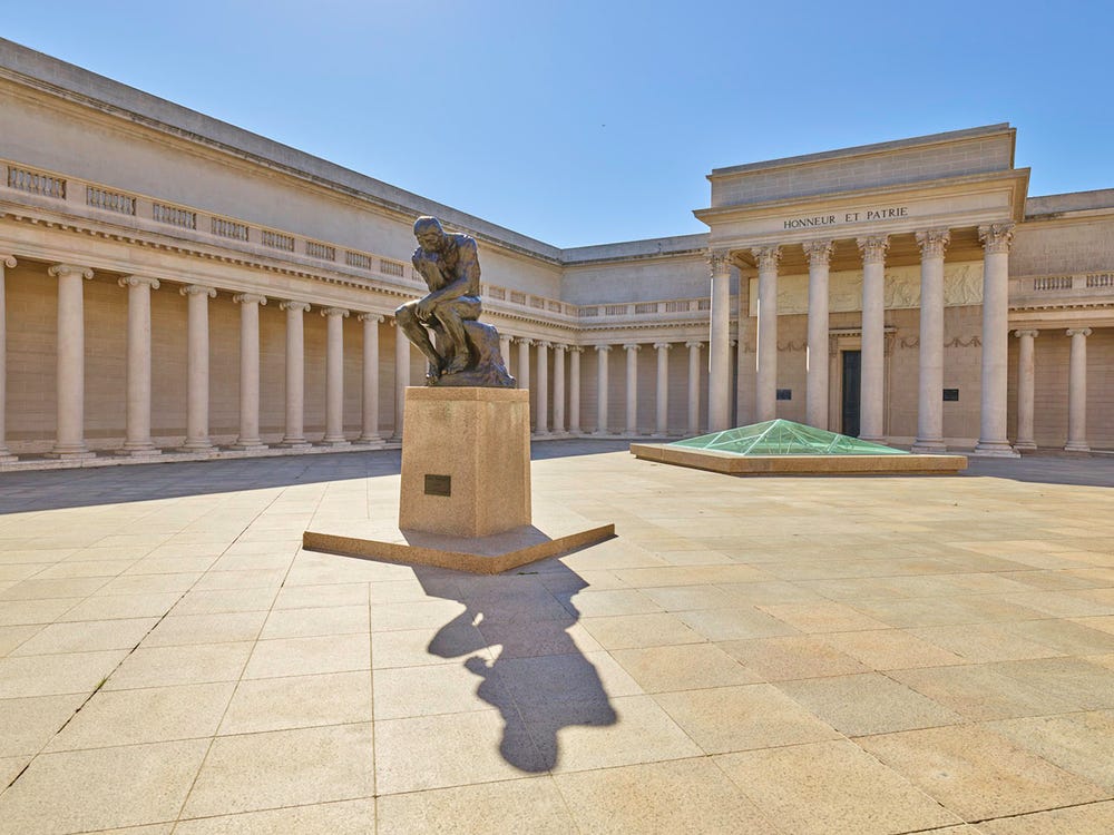 Sculpture of a man with his head resting on his fist in Legion of Honor courtyard